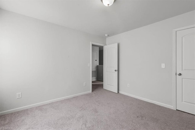 unfurnished bedroom with baseboards and carpet