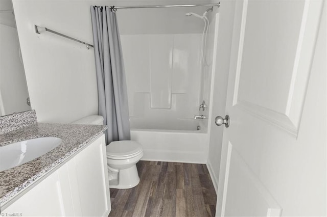 full bathroom with shower / tub combo, wood finished floors, toilet, and vanity