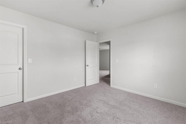 unfurnished bedroom featuring baseboards and carpet floors