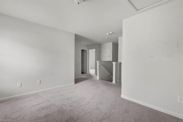spare room with carpet flooring and baseboards