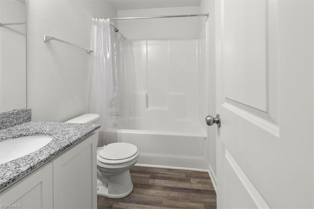full bath featuring toilet, shower / bath combo, wood finished floors, and vanity