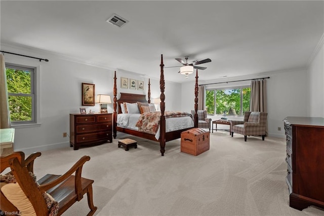 bedroom with light colored carpet, visible vents, ceiling fan, baseboards, and ornamental molding