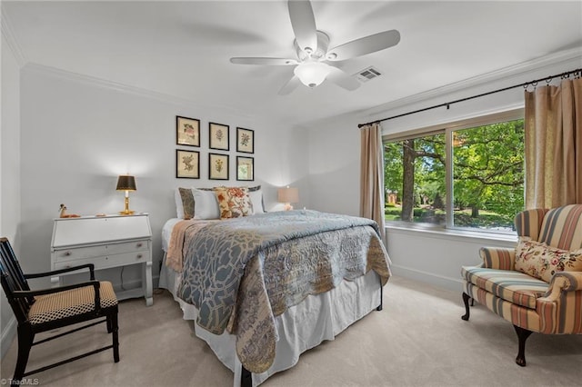 carpeted bedroom featuring visible vents, a ceiling fan, ornamental molding, and baseboards