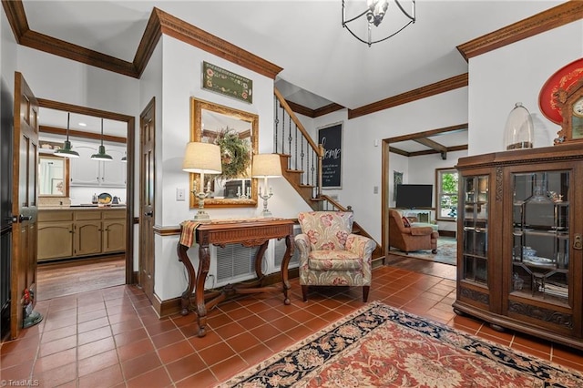 living area with dark tile patterned floors, stairway, and ornamental molding