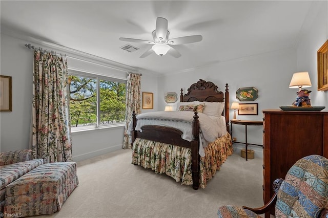 carpeted bedroom with baseboards, visible vents, a ceiling fan, and crown molding