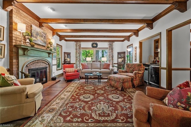 living room with a fireplace, wood finished floors, crown molding, and beamed ceiling