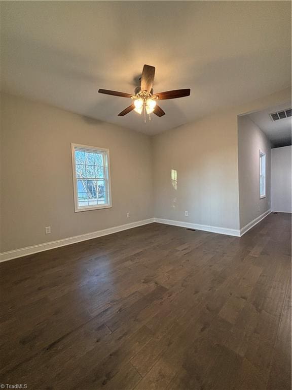 unfurnished room with ceiling fan and dark hardwood / wood-style floors