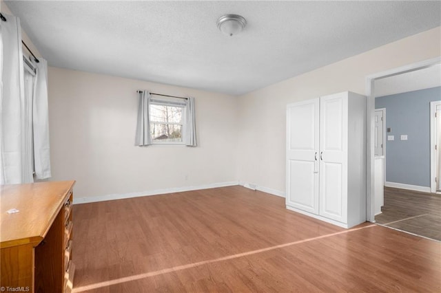 unfurnished bedroom featuring hardwood / wood-style floors and a closet