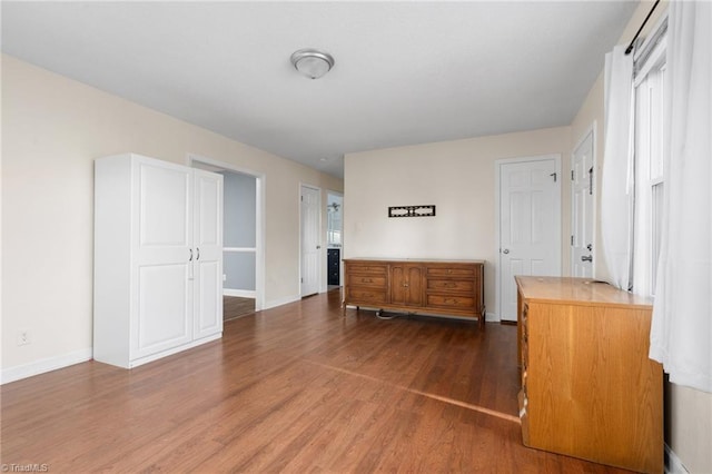 bedroom with dark hardwood / wood-style floors