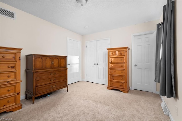 bedroom featuring light carpet