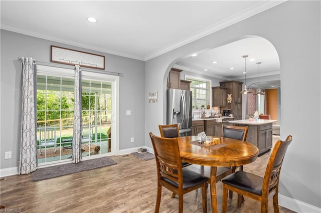 724-0 Tom Cook Rd, Pilot Mountain, NC 27041 - dining space featuring arched walkways, ornamental molding, wood finished floors, and recessed lighting