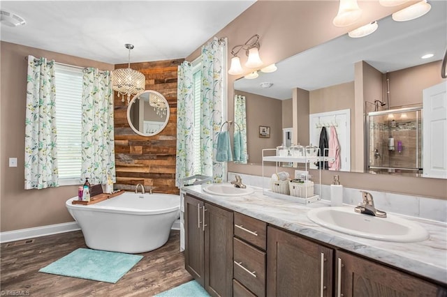 724-0 Tom Cook Rd, Pilot Mountain, NC 27041 - full bathroom with healthy amount of natural light, a freestanding bath, a stall shower, and wood finished floors
