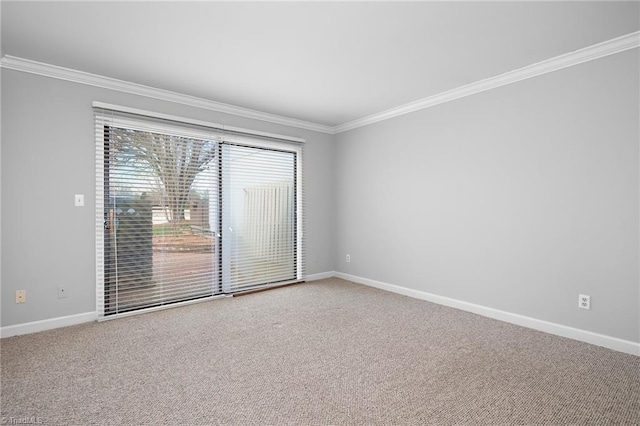 carpeted spare room with baseboards and ornamental molding