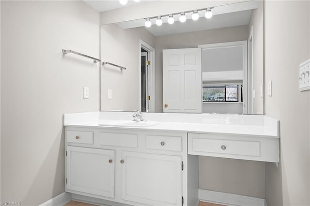 bathroom with vanity and baseboards