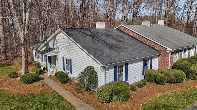 view of side of property with brick siding and a chimney