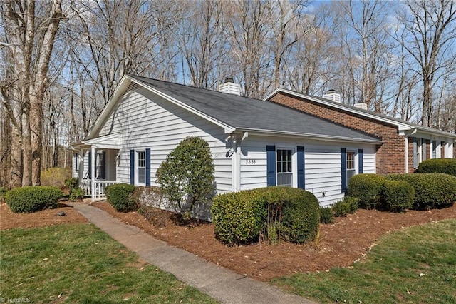 view of side of home with a chimney