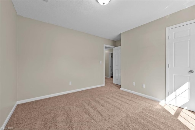 interior space with baseboards and carpet