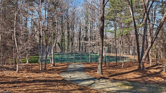 view of tennis court with fence