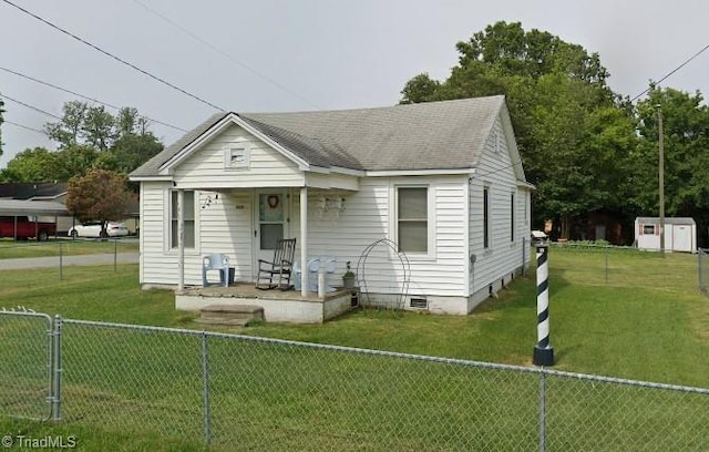 bungalow-style home with a front yard and a shed