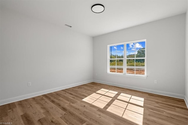 spare room with wood-type flooring