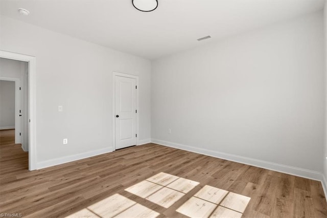 unfurnished room with light hardwood / wood-style flooring