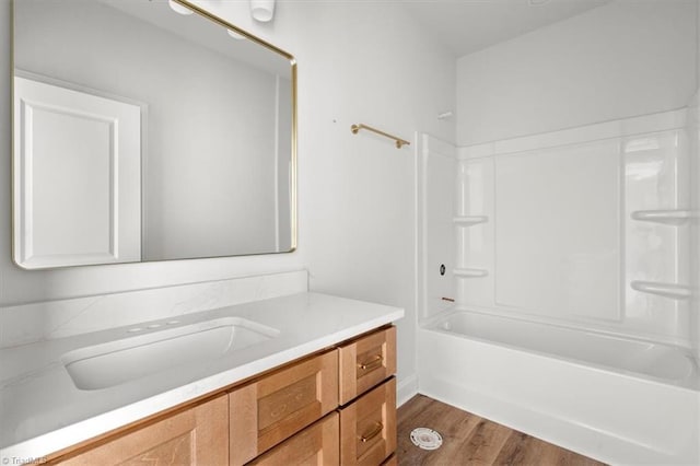 bathroom featuring vanity, hardwood / wood-style floors, and shower / bathtub combination