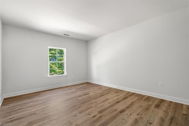 unfurnished room with light wood-type flooring