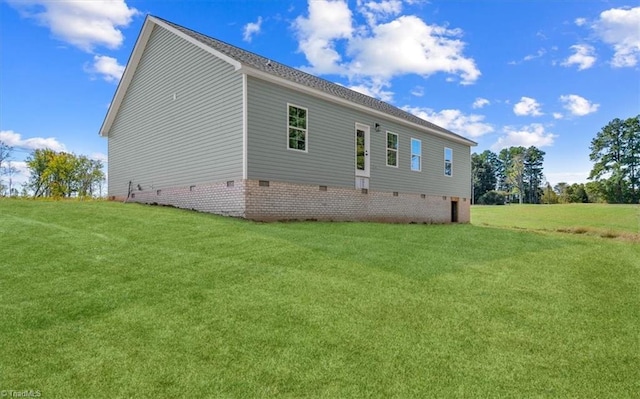 view of side of property with a yard