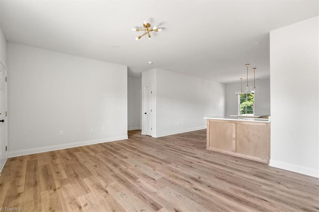 spare room with light hardwood / wood-style flooring