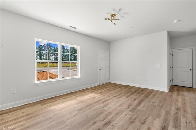 spare room featuring light wood-type flooring