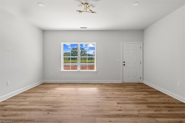 unfurnished room featuring light wood-type flooring