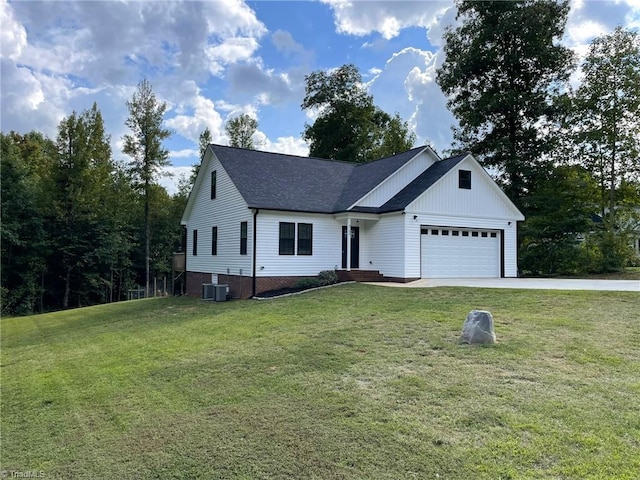 view of front of property with a front yard, a garage, and central air condition unit