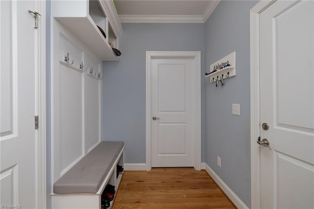 mudroom with crown molding and light hardwood / wood-style floors