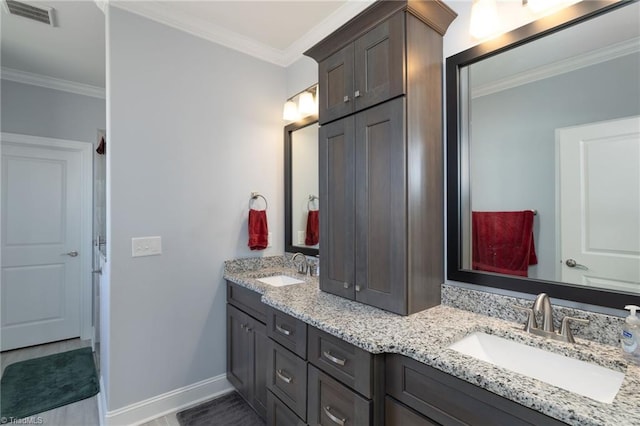 bathroom with ornamental molding and vanity