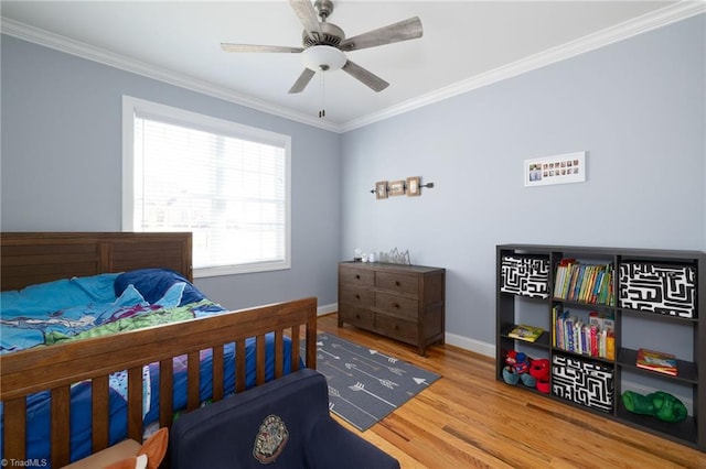 bedroom featuring crown molding, hardwood / wood-style floors, and ceiling fan