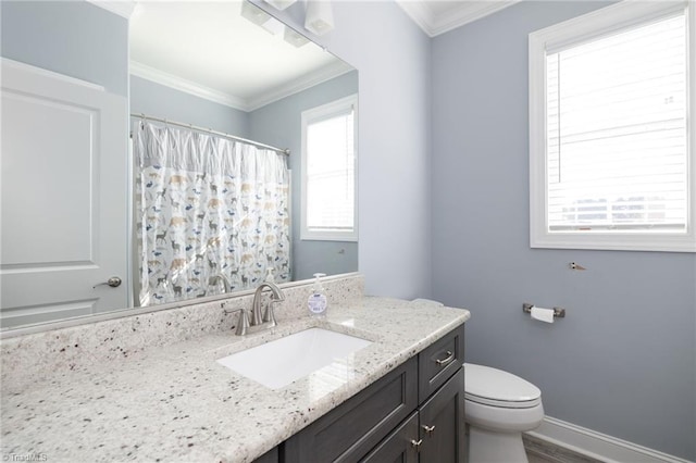 bathroom with ornamental molding, vanity, and toilet