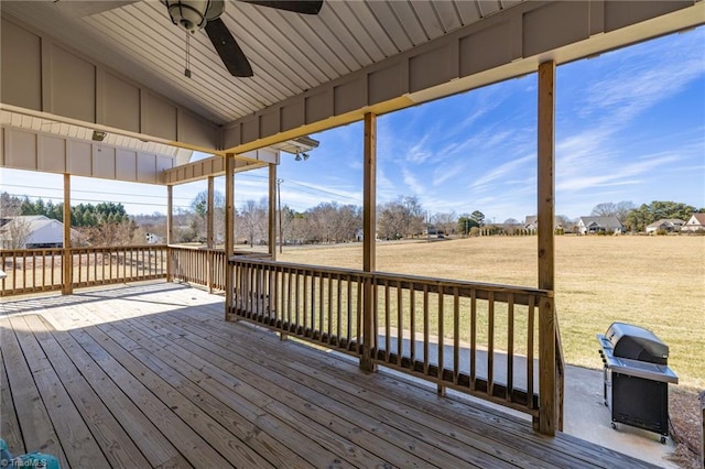 wooden terrace featuring area for grilling, a yard, and ceiling fan