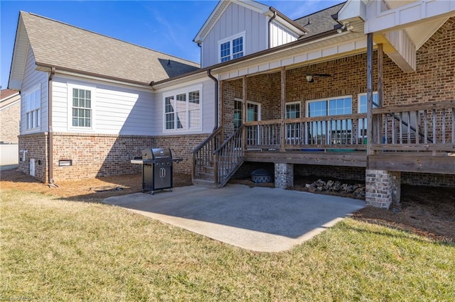 rear view of house with a patio area and a lawn