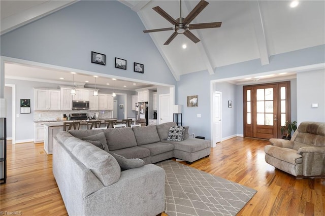 living room with high vaulted ceiling, light hardwood / wood-style floors, beamed ceiling, and ceiling fan