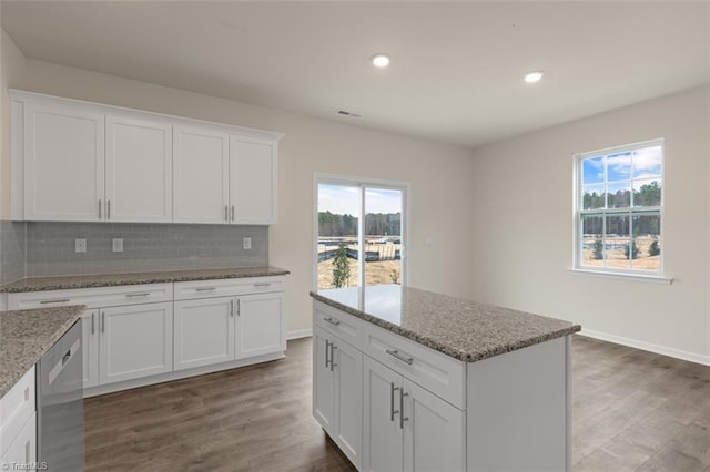 kitchen featuring dishwasher, tasteful backsplash, plenty of natural light, and wood finished floors