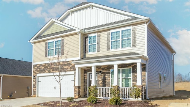 craftsman-style home featuring driveway, stone siding, an attached garage, and a porch