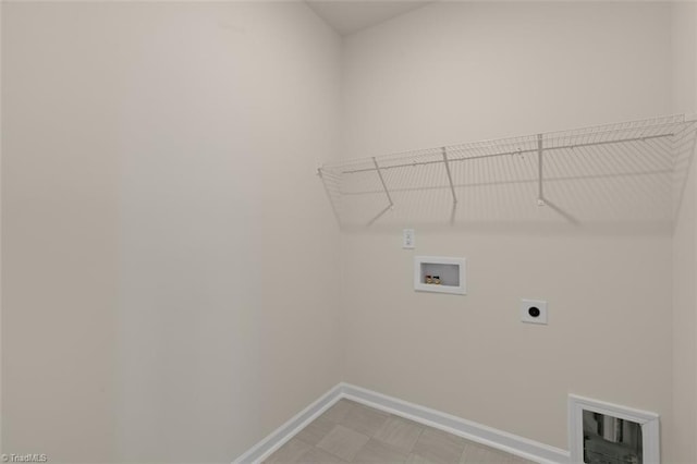 laundry area featuring laundry area, washer hookup, electric dryer hookup, and baseboards