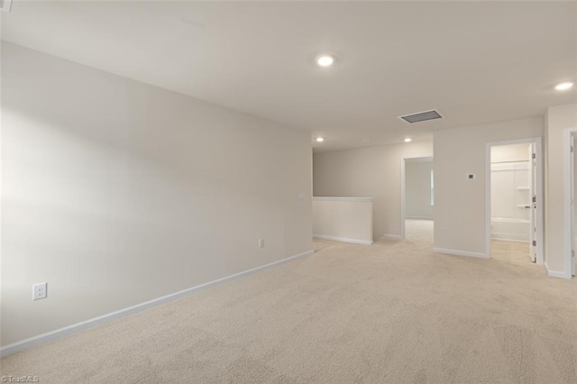 unfurnished room featuring light carpet, baseboards, visible vents, and recessed lighting