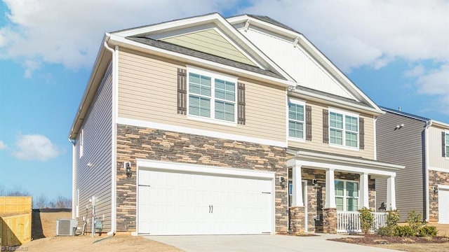 craftsman-style house with a porch, central AC, a garage, stone siding, and driveway