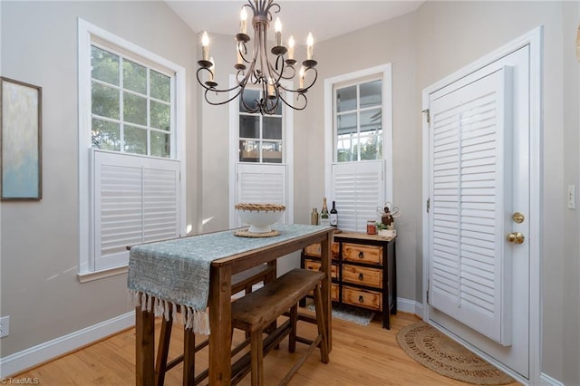 dining area featuring a notable chandelier and light hardwood / wood-style floors