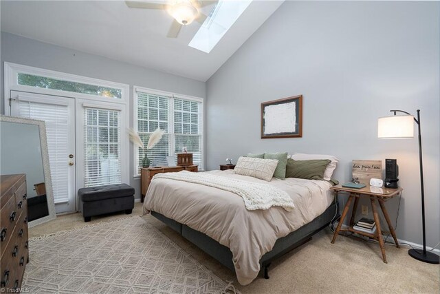 bedroom with ceiling fan, light carpet, access to exterior, and multiple windows