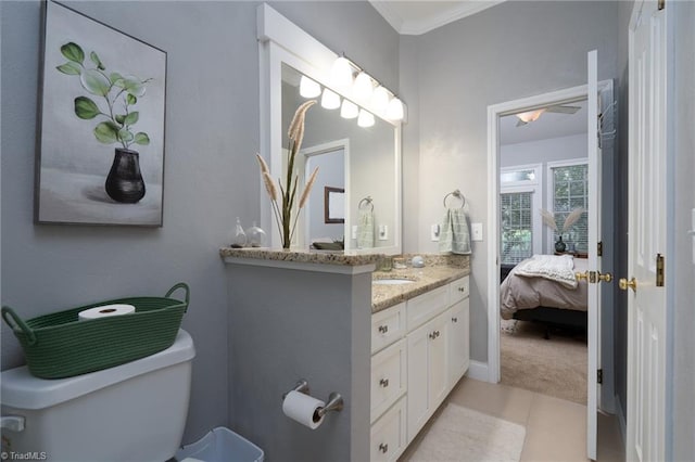 bathroom featuring crown molding, vanity, tile patterned flooring, and toilet