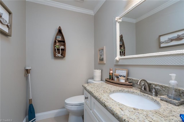 bathroom with ornamental molding, vanity, and toilet