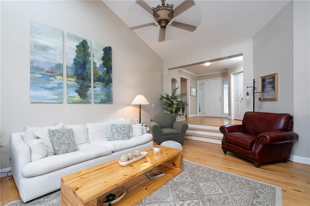 living room featuring wood-type flooring, vaulted ceiling, and ceiling fan