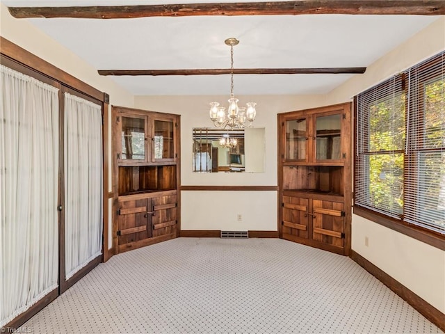 unfurnished dining area featuring a chandelier, vaulted ceiling with beams, and carpet floors